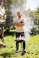 Image showing man cooking meat on barbecue grill at summer party