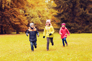 Image showing group of happy little kids running outdoors