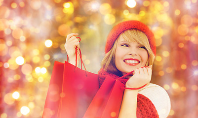 Image showing happy woman in winter clothes with shopping bags