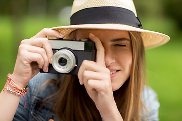 Image showing close up of woman with camera shooting outdoors