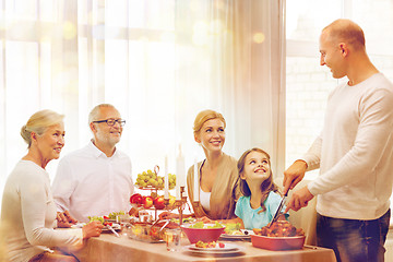 Image showing smiling family having holiday dinner at home