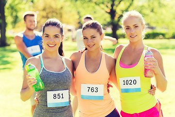 Image showing women with racing badge numbers and water bottles