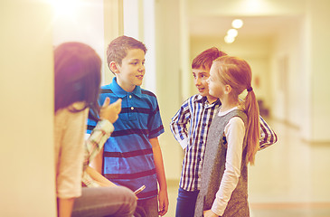 Image showing group of smiling school kids talking in corridor