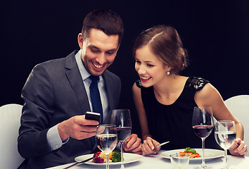 Image showing smiling couple eating main course at restaurant