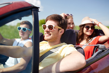 Image showing happy friends driving in cabriolet car