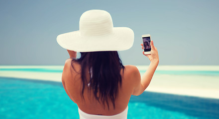 Image showing smiling young woman taking selfie with smartphone