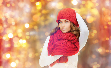 Image showing happy woman in hat, scarf and pullover over lights