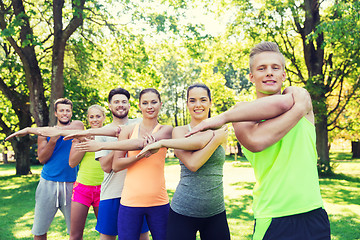 Image showing group of friends or sportsmen exercising outdoors