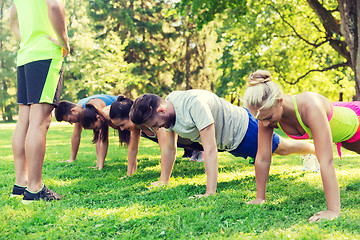 Image showing group of friends or sportsmen exercising outdoors