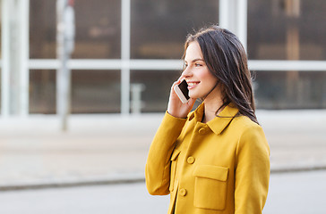 Image showing smiling young woman or girl calling on smartphone