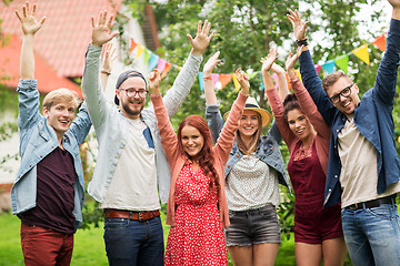 Image showing happy teen friends waving hands at summer garden