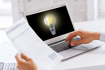 Image showing businessman with laptop computer working at office