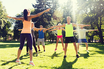 Image showing group of happy friends exercising outdoors