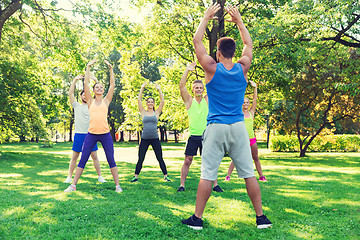 Image showing group of friends or sportsmen exercising outdoors