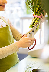 Image showing close up of woman with flowers and scissors