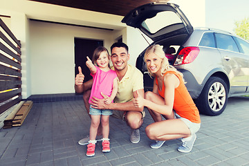 Image showing happy family with car showing thumbs up at parking