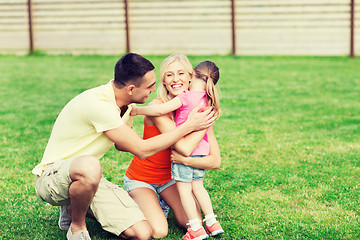 Image showing happy family hugging outdoors