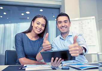 Image showing smiling businesspeople with tablet pc in office