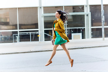 Image showing happy young woman or teenage girl on city street