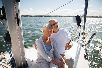 Image showing senior couple taking selfie on sail boat or yacht
