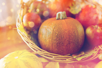 Image showing close up of pumpkins in basket on wooden table