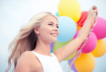 Image showing woman with colorful balloons outside