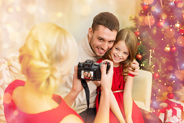 Image showing mother taking picture of father and daughter