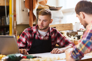 Image showing carpenters with laptop and blueprint at workshop