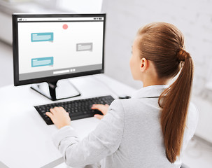 Image showing businesswoman with messenger on computer at office