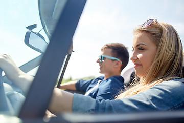 Image showing happy couple driving in cabriolet car outdoors