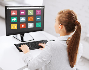 Image showing businesswoman with menu icons on office computer