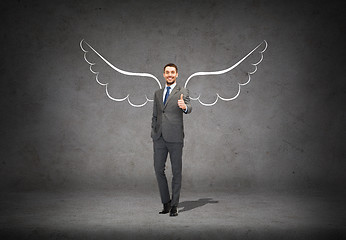 Image showing businessman with angel wings showing thumbs up