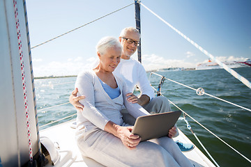 Image showing senior couple with tablet pc on sail boat or yacht