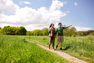 Image showing happy couple with backpacks hiking outdoors