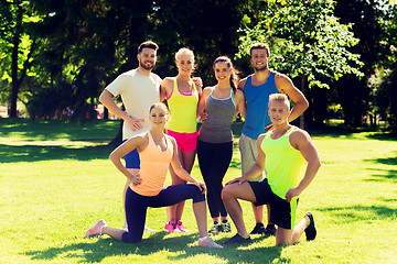 Image showing group of happy friends or sportsmen outdoors