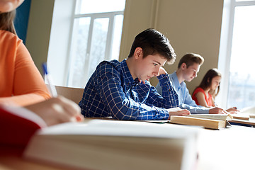 Image showing group of students with books writing school test