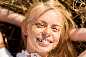 Image showing happy young woman lying on cereal field