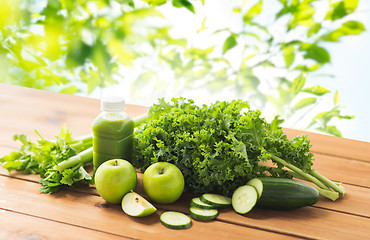 Image showing close up of bottle with green juice and vegetables