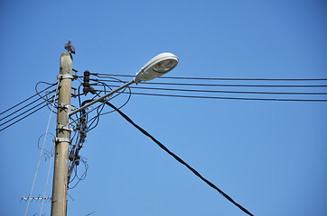 Image showing Lamp post with many cables