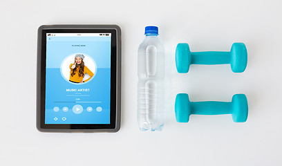 Image showing close up of tablet pc, dumbbells and water bottle