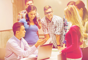 Image showing group of students and teacher with laptop