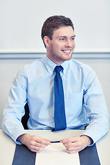 Image showing smiling businessman sitting in office