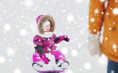 Image showing happy little kid on sled outdoors in winter