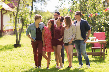 Image showing happy teenage friends hugging at summer garden