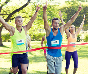 Image showing happy young male runner winning on race finish