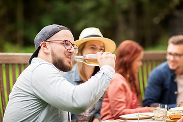 Image showing man drinking beer with friends at summer party
