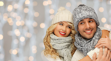 Image showing happy family couple in winter clothes hugging