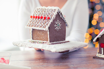 Image showing close up of woman showing gingerbread house