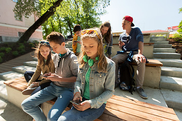 Image showing group of teenage friends with smartphones outdoors