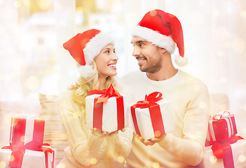 Image showing happy couple at home exchanging christmas gifts